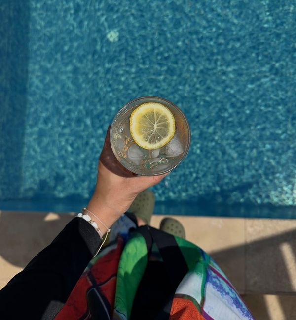 Overhead view of a yoga mat, water bottle and a towel.